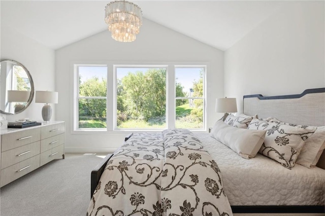 bedroom featuring lofted ceiling, light colored carpet, and an inviting chandelier