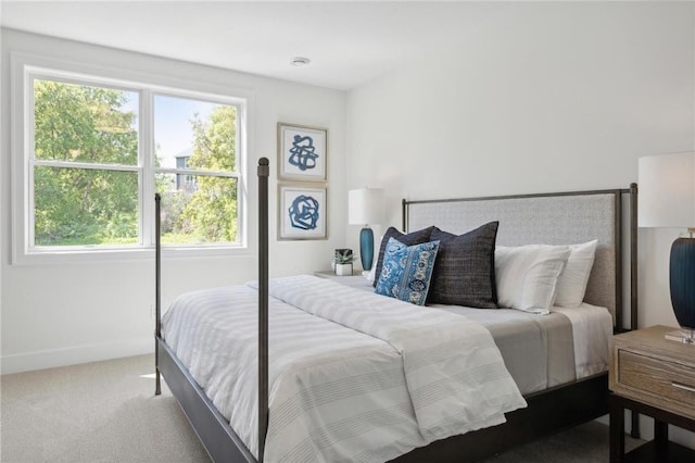 bedroom featuring baseboards, multiple windows, and carpet flooring