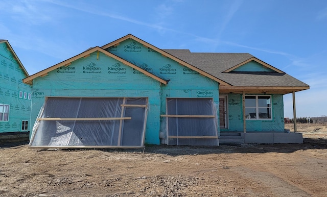 property under construction featuring roof with shingles