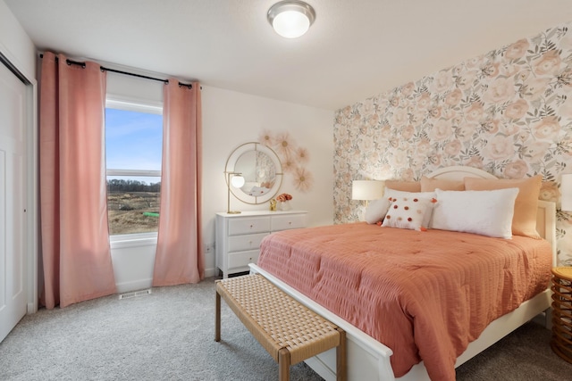 bedroom featuring visible vents and light carpet