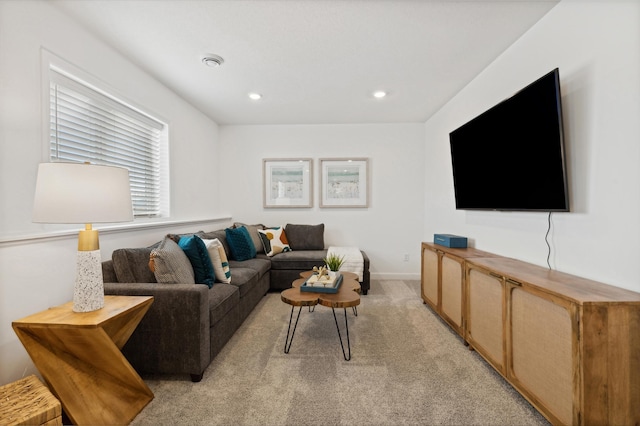 living room featuring recessed lighting, baseboards, and light colored carpet