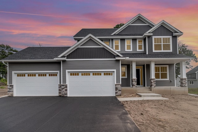 craftsman-style home featuring aphalt driveway, a porch, a garage, and roof with shingles