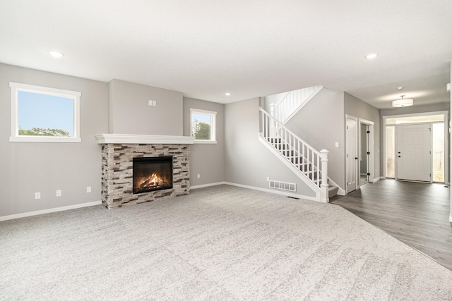 unfurnished living room with stairs, recessed lighting, baseboards, and visible vents