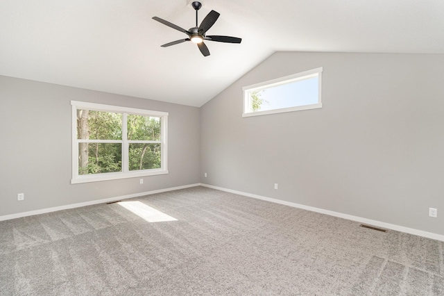 spare room with baseboards, lofted ceiling, a ceiling fan, and carpet flooring