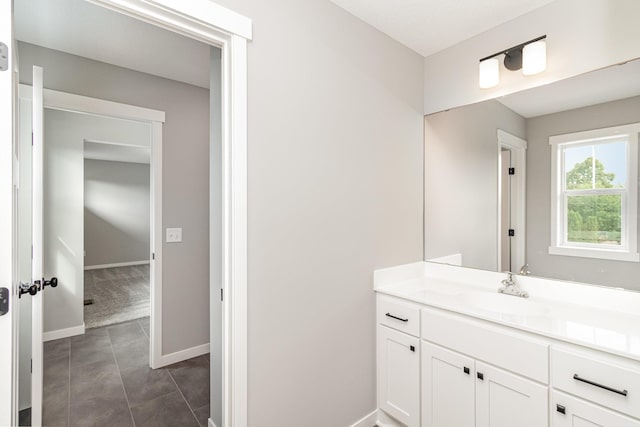 bathroom featuring baseboards, vanity, and tile patterned flooring