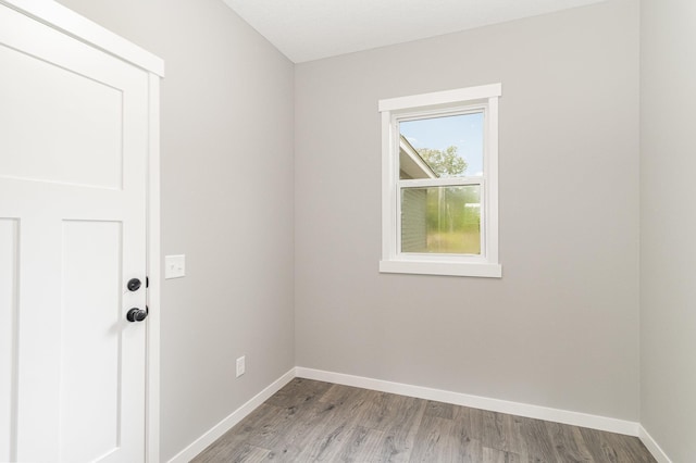 empty room with wood finished floors and baseboards