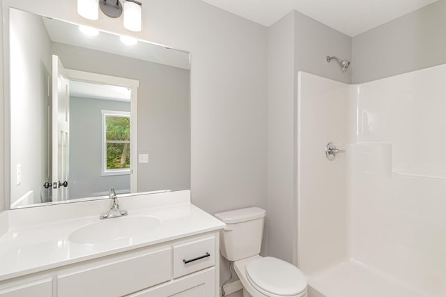 bathroom with a shower, toilet, and vanity