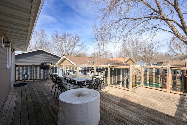 wooden deck featuring outdoor dining area