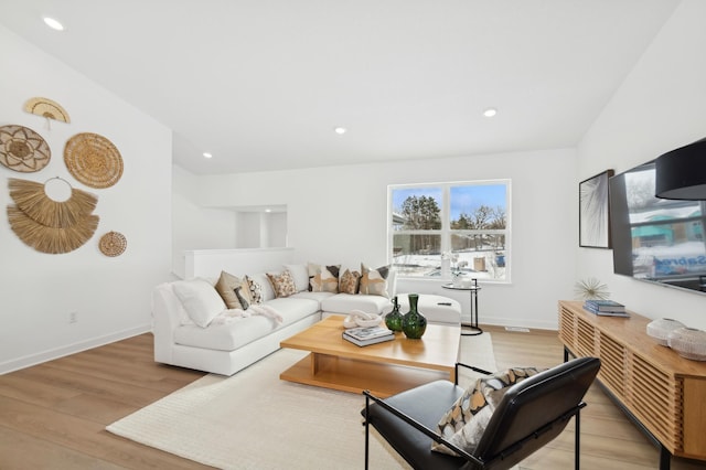 living area with recessed lighting, light wood-type flooring, and baseboards