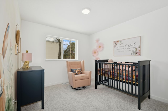 carpeted bedroom with a nursery area and baseboards