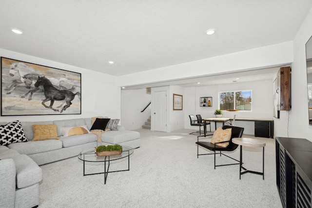 living area featuring stairway, recessed lighting, and light colored carpet