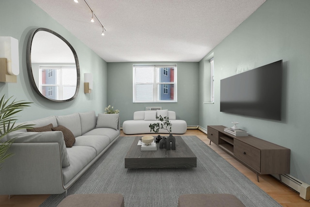 living room with track lighting, light wood-type flooring, baseboard heating, and a textured ceiling