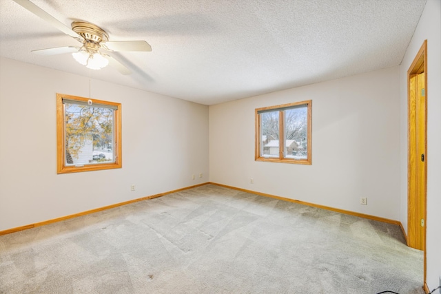 interior space featuring carpet, baseboards, and a textured ceiling