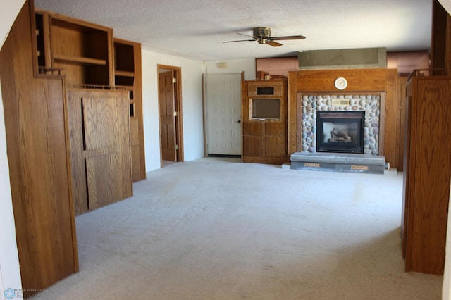 203 4th St, Argusville, ND 58005 - unfurnished living room featuring carpet floors, a ceiling fan, a fireplace, and a textured ceiling