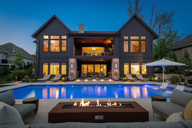 18411 9th Ave N, Plymouth, MN 55447 - rear view of property featuring a balcony, an outdoor living space with a fire pit, a patio, a chimney, and an outdoor pool