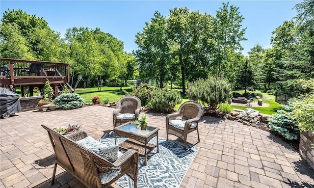 view of patio / terrace with grilling area, a fire pit, and a deck