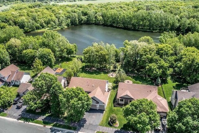 birds eye view of property with a wooded view, a residential view, and a water view