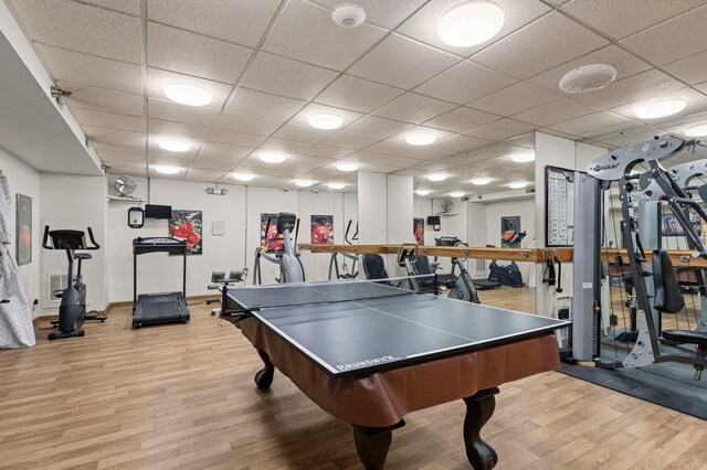 game room with wood finished floors and a drop ceiling