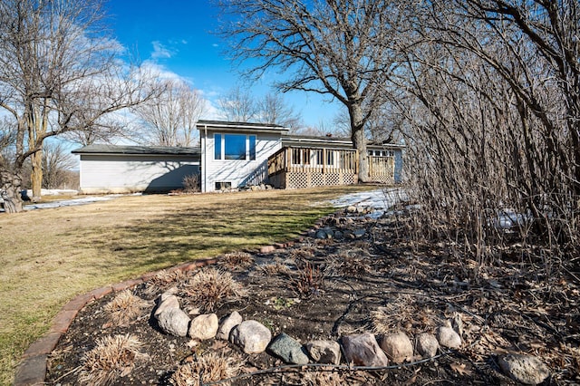 view of front of home featuring a deck and a front lawn