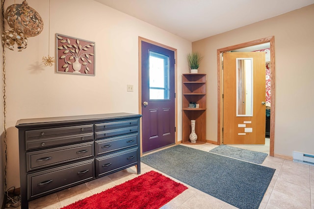 foyer featuring light tile patterned floors, baseboards, and a baseboard radiator