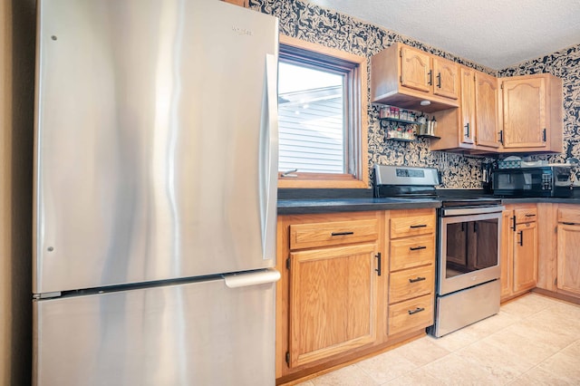 kitchen featuring light tile patterned floors, decorative backsplash, appliances with stainless steel finishes, a textured ceiling, and dark countertops