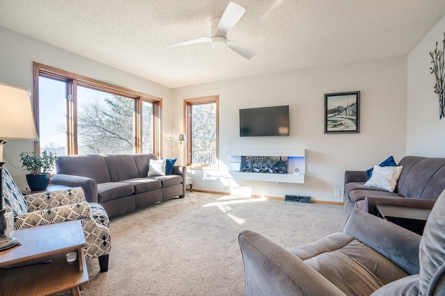 living room featuring plenty of natural light, a textured ceiling, and carpet flooring