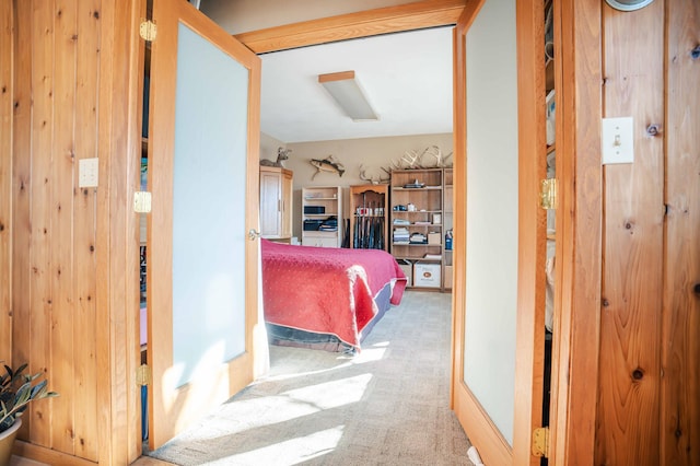 hallway with wood walls and carpet floors