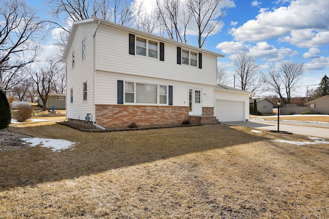 colonial home featuring a garage, brick siding, and concrete driveway