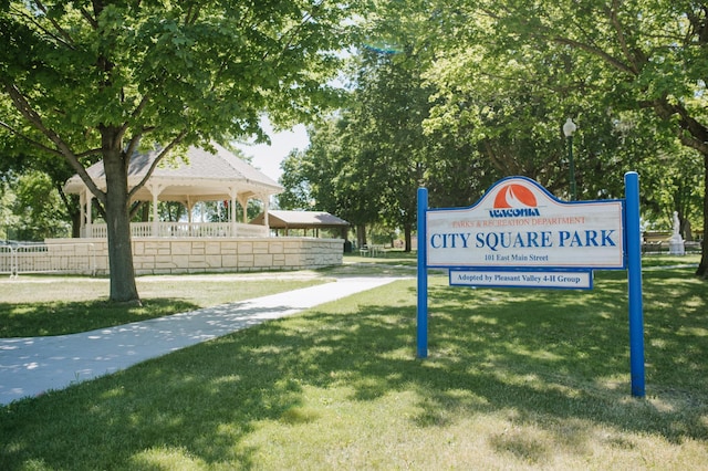 view of home's community featuring a lawn and fence