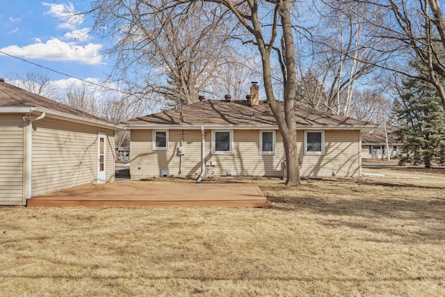 rear view of property with a lawn and a chimney