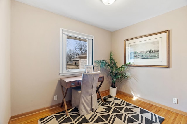 home office featuring wood finished floors and baseboards