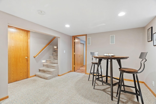 carpeted dining room featuring recessed lighting, baseboards, and stairs