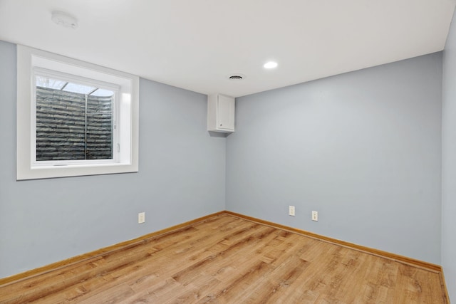 unfurnished room featuring visible vents, baseboards, and light wood-style flooring