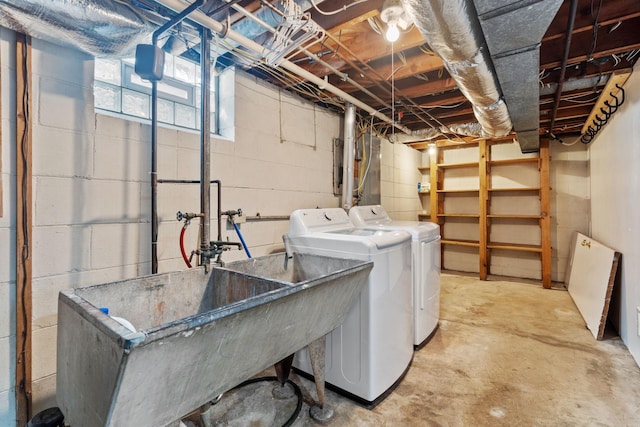 clothes washing area with laundry area, washing machine and dryer, and a sink