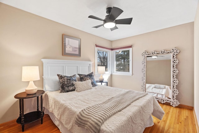 bedroom with ceiling fan and light wood-style floors