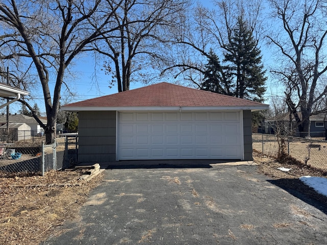 detached garage featuring fence