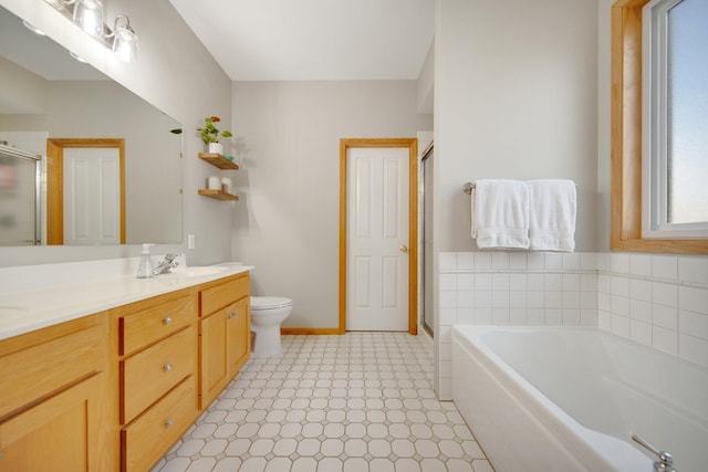 bathroom featuring tile patterned floors, toilet, a stall shower, a bath, and vanity