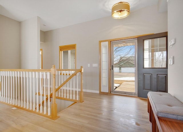 entrance foyer with baseboards and light wood finished floors