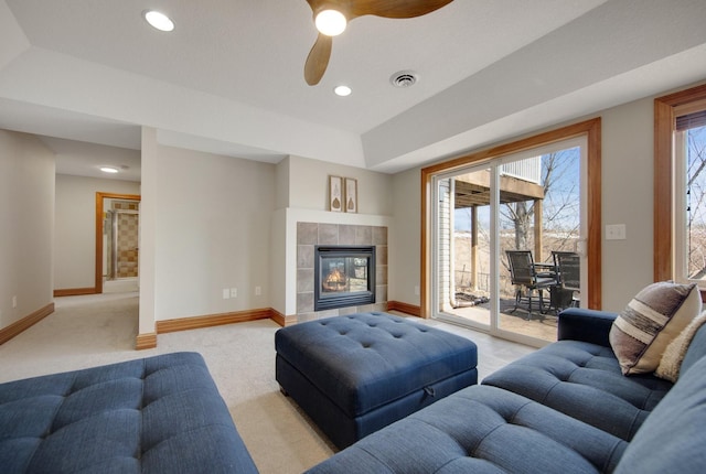 living area with a wealth of natural light, visible vents, and baseboards