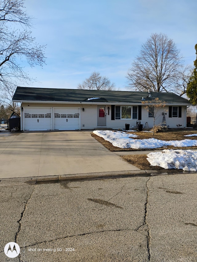 view of front of property featuring concrete driveway and a garage