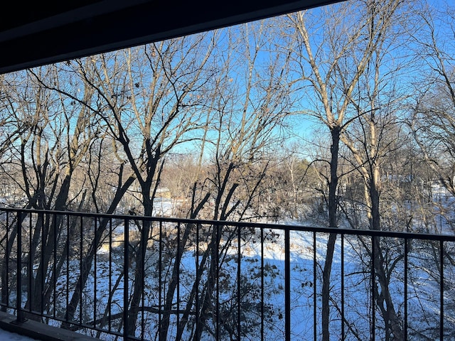 view of snow covered back of property