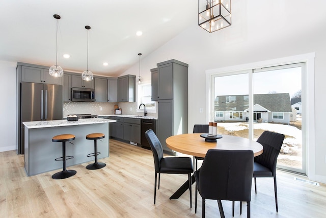 dining area featuring recessed lighting, light wood-style floors, visible vents, and high vaulted ceiling