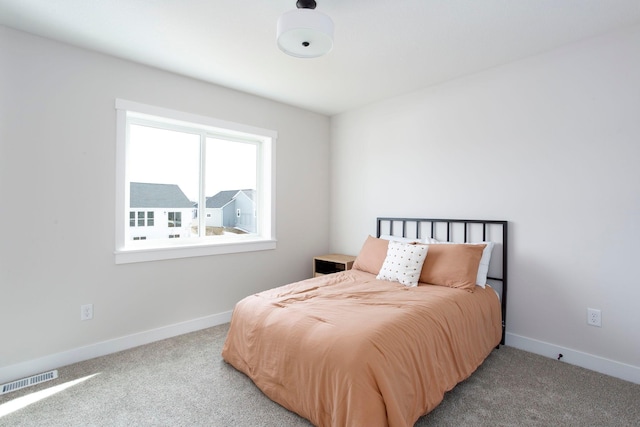 bedroom featuring baseboards, visible vents, and carpet floors