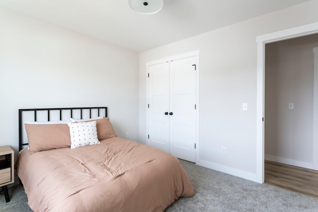 bedroom with a closet, baseboards, and carpet