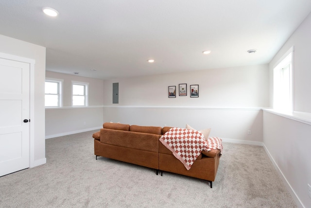 carpeted living area featuring recessed lighting and baseboards