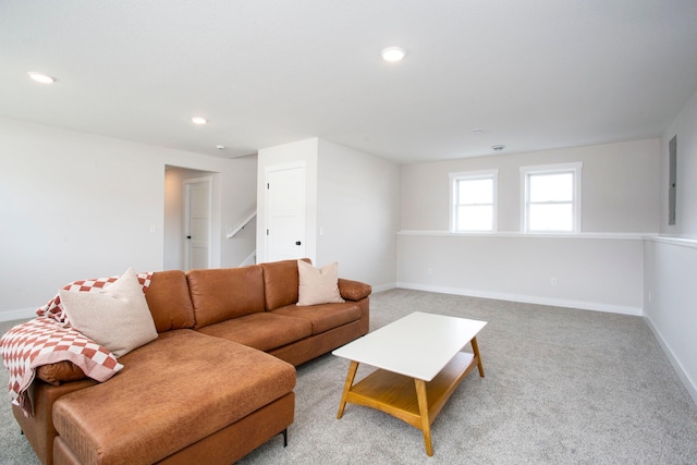 living area with light carpet, recessed lighting, stairs, and baseboards