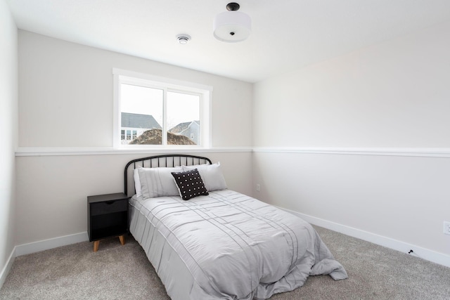 bedroom featuring baseboards and light colored carpet