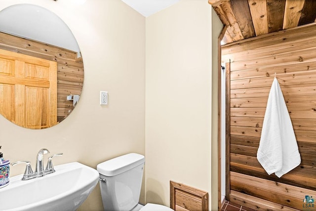 half bathroom featuring toilet and a sink