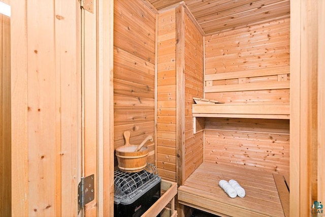 relaxing sauna / steam room with wood walls and wood ceiling
