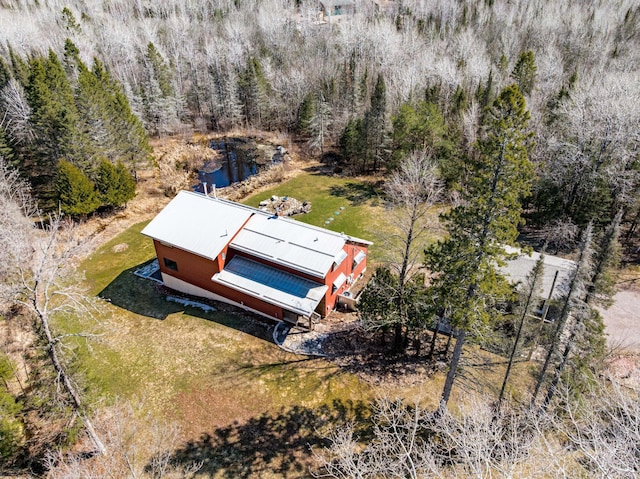 view of subject property featuring a forest